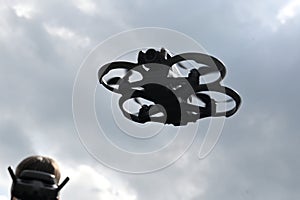 Drone is flying in the sky. Operator controls the drone