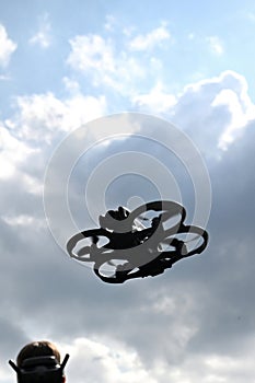 Drone is flying in the sky. Operator controls the drone
