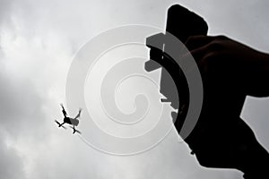 Drone is flying in the sky. Operator controls the drone