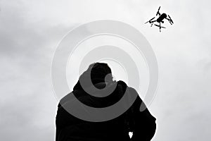 Drone is flying in the sky. Operator controls the drone.