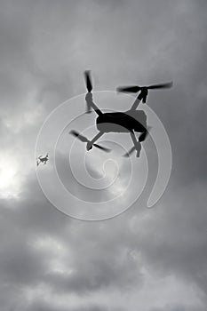 Drone is flying in the sky. Operator controls the drone.