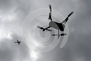 Drone is flying in the sky. Operator controls the drone.