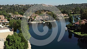 Drone flyover Calabasas lake and homes of rich and famous, daytime