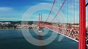 Drone footage of the 25 De April Bridge. Red bridge in Lisbon, Portugal. Tagus