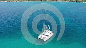 Drone footage aerial top view of catamaran sailing in the open sea