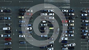 Drone footage cars moving at parking. Copter view people leaving car at parking