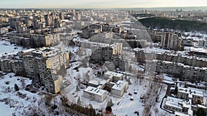 Drone footage of old multistory apartment blocks covered by snow during winter morning