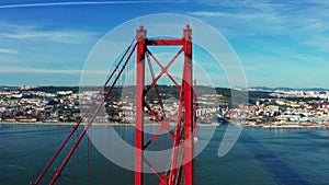 Drone footage over the 25 De April Bridge. Red bridge in Lisbon, Portugal. Tagus