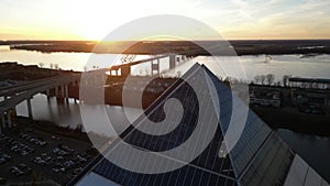 Drone footage over the Memphis Pyramid and Hernando de Soto Bridge at sunset in Tennessee, USA