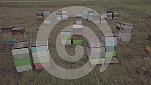 drone footage past bee hives in north dakota pasture with green grass