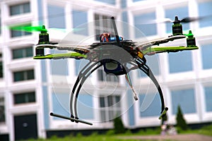 Drone with green propeller is flying