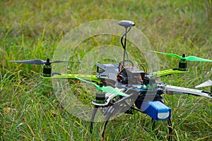 Drone with green propeller on green grass