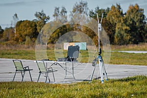 A drone control station set up at a table in an autumn landscape