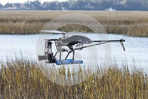 Drone helicopter flying over water