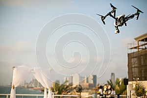 Drone hovering in the sky above the chuppah before the Jewish wedding ceremony against the backdrop