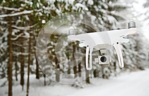 Drone hovering in winter forest