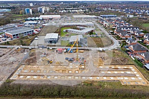 Drone image of a large construction site on which the concrete foundation for the columns of a factory building is being cast