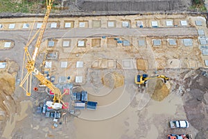 Drone image of a large construction site on which the concrete foundation for the columns of a factory building is being cast