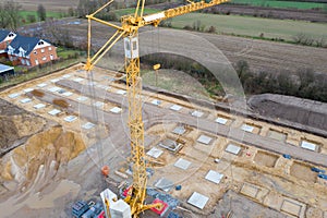 Drone image of a large construction site on which the concrete foundation for the columns of a factory building is being cast