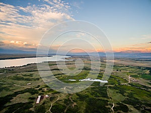 Drone Image at Sunset Over Lake With Clouds and Sun