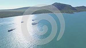 Drone, landscape and mountains with boats in ocean bay for sailing, exotic and summer vacation. Nature, island and