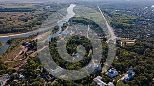 Drone landscape shots of ancient Chernihiv town with trees, river and buildings