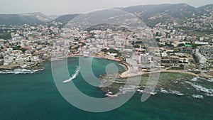 Drone landscape view of Batroun coastal city by turquoise sea in Lebanon