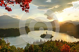 DRONE, LENS FLARE: Idyllic shot of famous lake Bled on a sunny summer evening.