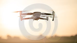 Drone like Mavic 2 Pro flying during sunset photo