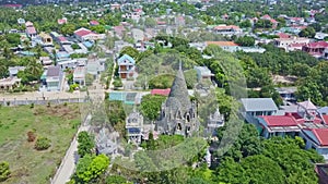 Drone moves to Buddhist temple cone tower against city