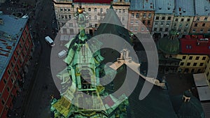 Drone moving up from authentic Latin Cathedral spire in Lviv, Ukraine, revealing peaceful streets, old European heritage