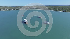 Drone, nature and tropical with boats in ocean bay for sailing, exotic and summer vacation. Landscape, island and