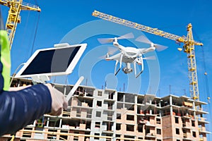 Drone operated by construction female worker on building site