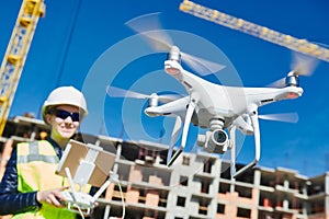 Drone operated by construction female worker on building site