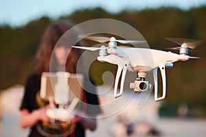 Drone operated by young man flying over an sea