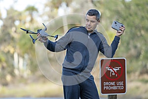 Drone operator is disappointed because he isn't allowed to fly his quadcopter in national park no drone area. Man is