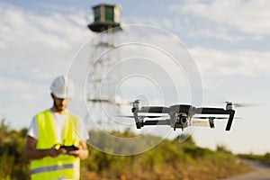 Drone operator piloting a drone