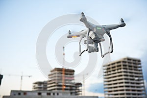 Drone over construction site. video surveillance or industrial inspection