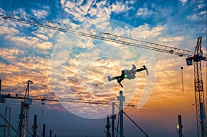 Drone over construction site. video surveillance or industrial inspection