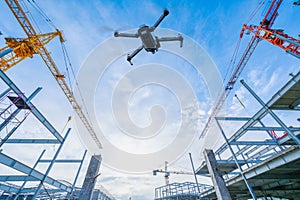 Drone over construction site. video surveillance or industrial inspection