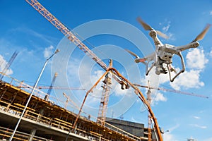 Drone over construction site. video surveillance or industrial inspection