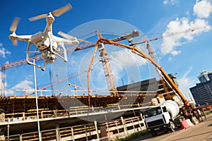 Drone over construction site. video surveillance or industrial inspection photo