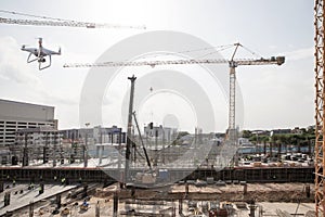 Drone over construction site. video surveillance or industrial inspection.