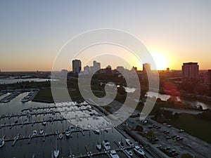 Drone over harbor with cityscape at seaside in Wisconsin at sunset