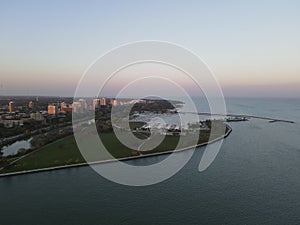 Drone over harbor with cityscape at seaside in Wisconsin at sunset