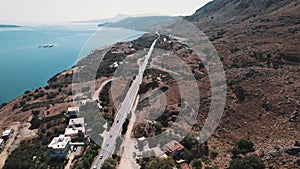 Drone perspective over Ormos Soudas near Chania. Road leading through wild hills of Greek coastline. Beautiful weather.