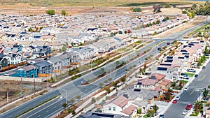 Drone photo of a community in Oakley, California with houses, cars, streets and solar