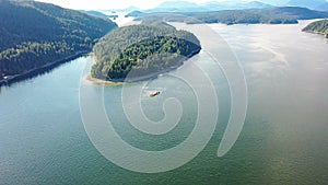 Drone photo forested islands in water against background mountains in distance. Nusa Penida Indonesia