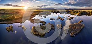 A drone photo of lake - pond bog with sun - Absolutely stunning aerial landscape sunset panorama