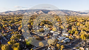 Drone  photo of Reno neighborhoods during the fall sesason looking towards the mountains photo